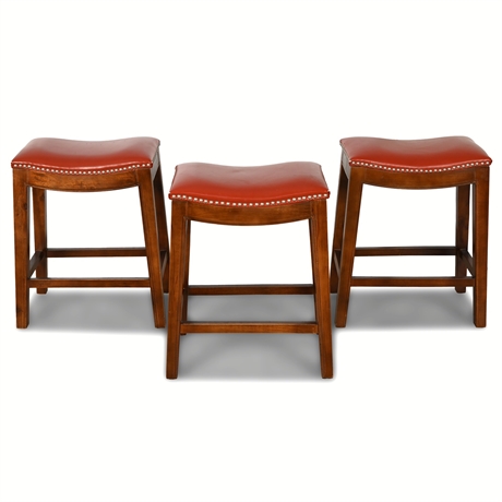 Charming Trio of Red Faux Leather Saddle Bar Stools with Nailhead Detail