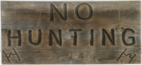 Vintage "No Hunting" Sign on Wood