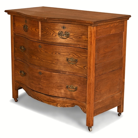 Antique American Oak Serpentine-Front Four-Drawer Chest on Casters, c. 1900